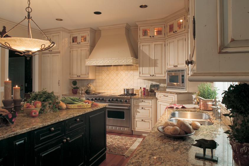 off white and black Dura Supreme cabinets, with granite countertops, tiled edged hood and stainless appliances | Marchand Creative Kitchens Cabinets New Orleans Metairie Mandeville LA