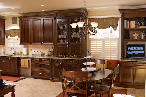 dark cabinets with granite countertops and window seat | Marchand Creative Kitchens Cabinets New Orleans Metairie Mandeville LA