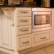 low seated microwave in off white cabinet island | Marchand Creative Kitchens Cabinets New Orleans Metairie Mandeville LA