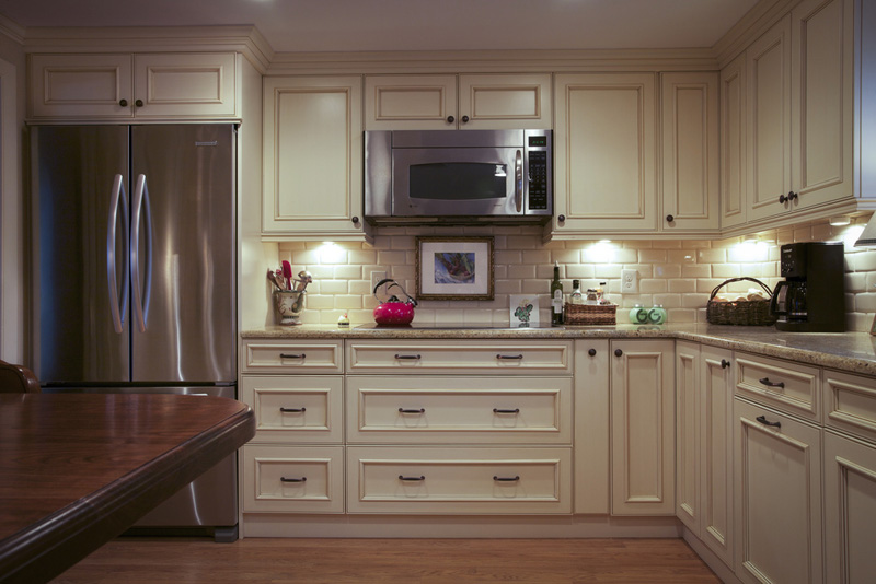 white cabinets with subway tile backsplash and wall, and stainless appliances | Marchand Creative Kitchens Cabinets New Orleans Metairie Mandeville LA