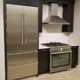 Liebherr Refrigerator, Zephyr Hood and Superiore Range with dark cabinets and white countertop | Marchand Creative Kitchens Cabinets New Orleans Metairie Mandeville LA