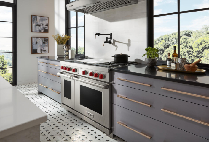 stainless Wolf oven with red knobs | Marchand Creative Kitchens